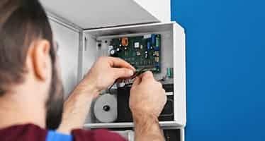 Electrician Fixing Circuit Board — Plumbers & Electricians in Ulladulla, NSW