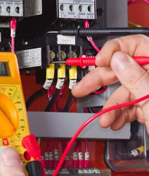 Electrician Using a Multimeter — Plumbers & Electricians in the Wollongong Region, NSW