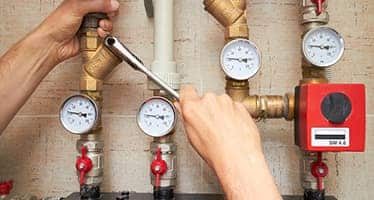 Gas Fitter Adjusting Pipes — Plumbers & Electricians in the Southern Highlands, NSW