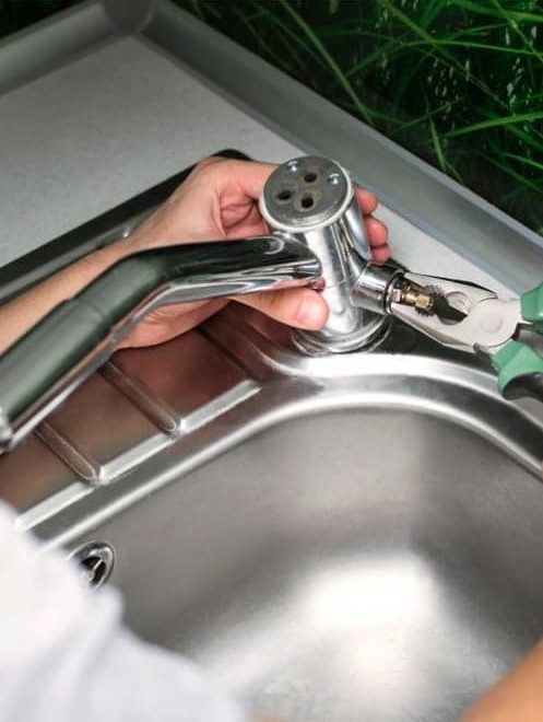 Repairing Kitchen Sink — Plumbers & Electricians in the Wollongong Region, NSW