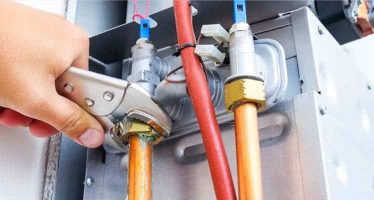 Gas Fitter Using Pipe Wrench — Plumbers & Electricians in the Wollongong Region, NSW