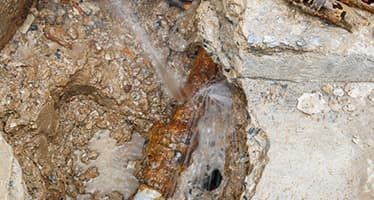 Concrete Excavated To Expose Blocked Drain Pipe — Plumbers & Electricians in Nowra, NSW