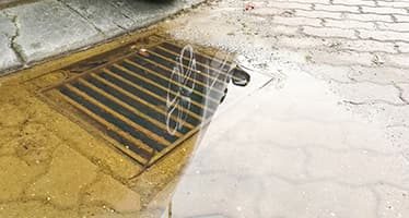 Water Pooling in Drainage Grate — Plumbers & Electricians in Shellharbour, NSW