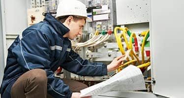 Electrician Inspecting Switchboard Wiring — Plumbers & Electricians in Shellharbour, NSW