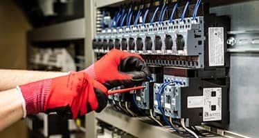 Electrician Securing Circuit Breaker to the Switchboard — Plumbers & Electricians in Shellharbour, NSW